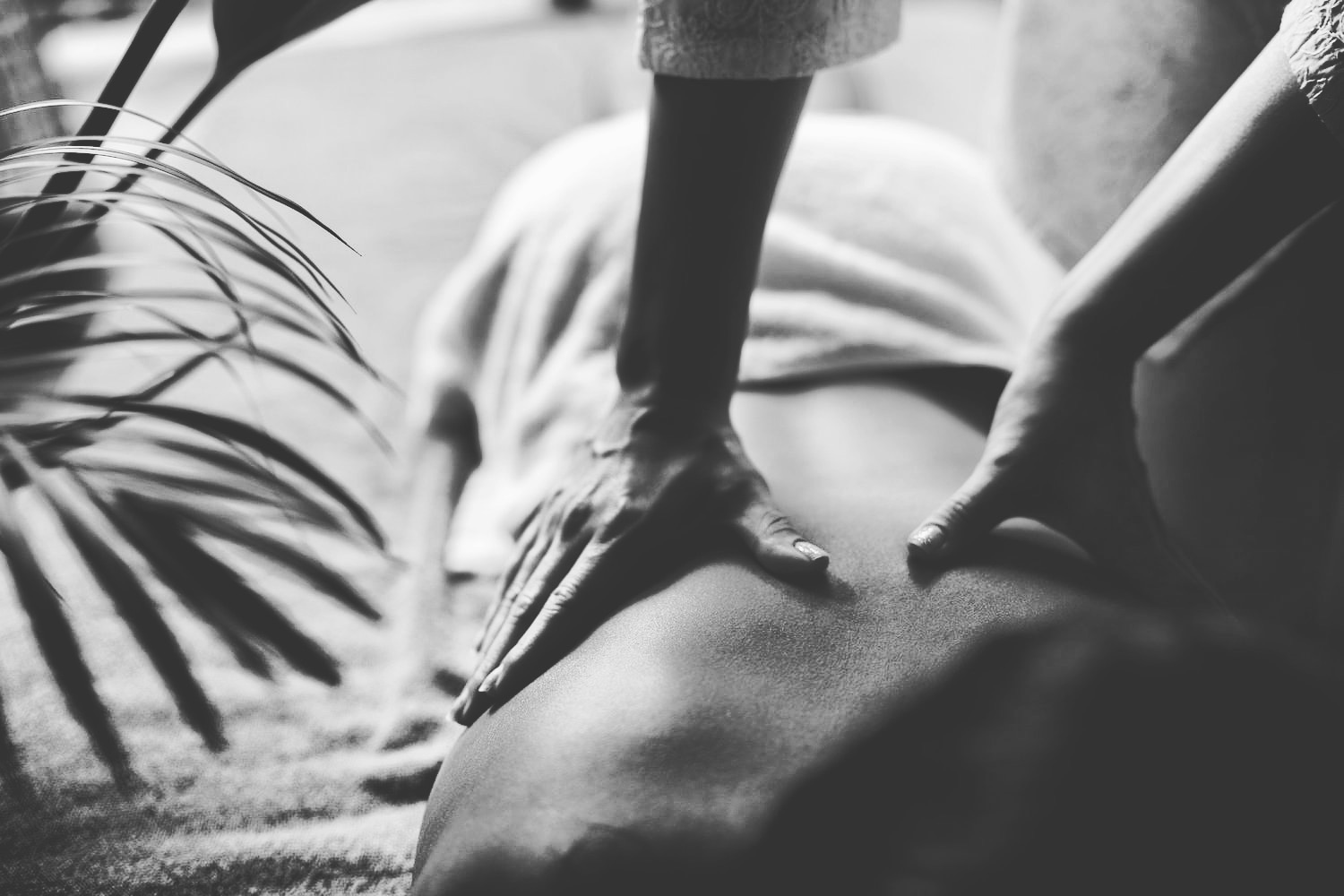 A deep tissue back massage in progress at Pressure London Massage, shot in black and white